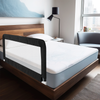 a white bed with a white comforter and pillows