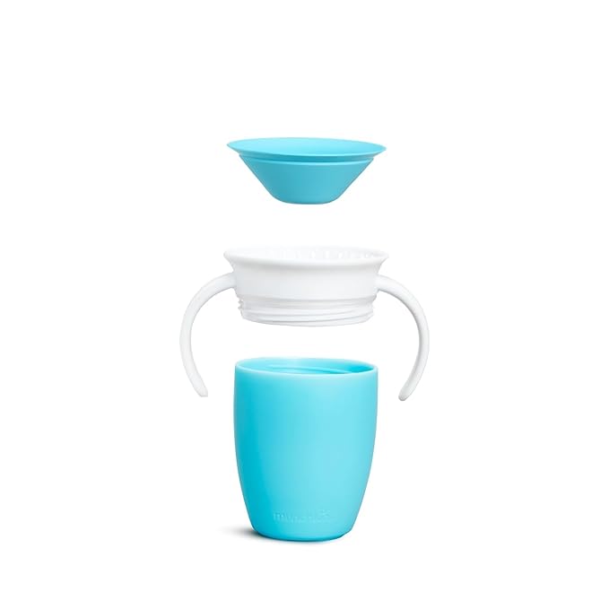 a white toothbrush in a blue glass cup