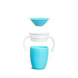 a white toothbrush in a blue glass cup
