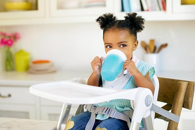 a young boy is sitting on a white chair